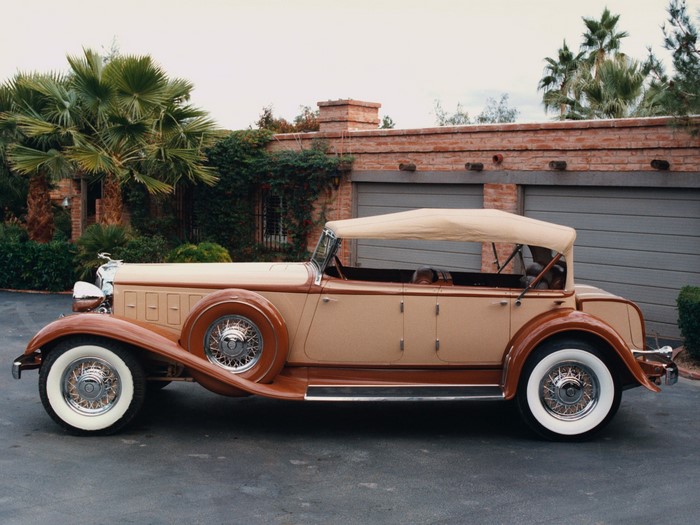 1930 Chrysler 77 convertible parked in front of a garage