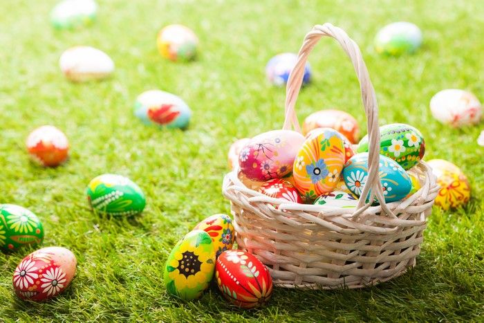 Easter eggs in a wicker basket on grass