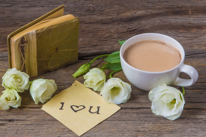 Still life with book, flowers, and hot chocolate