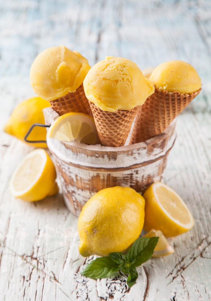 Lemon ice cream cones in a bucket with lemons