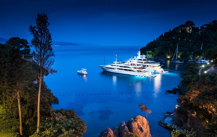 Luxury yachts docked in Portofino, Italy at night