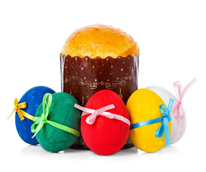 Easter Kulich and decorated eggs on white background
