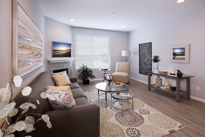 Living room with sofa, carpet, and tables