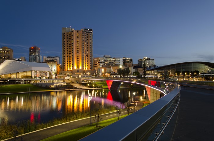 Adelaide cityscape with river and illuminated bridge at night