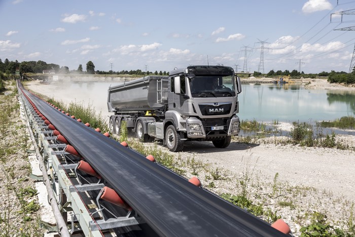 MAN SE dump truck at a quarry with conveyor belt