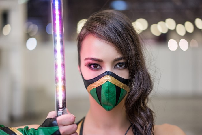 Woman in Jade Cosplay with Glowing Staff
