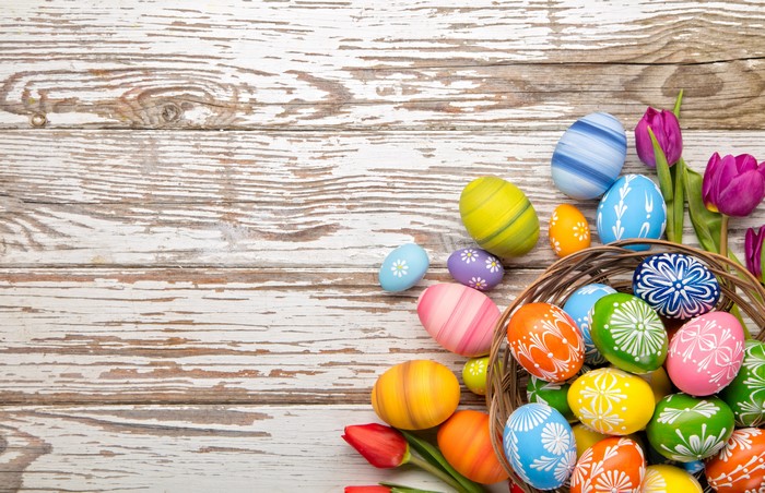 Easter eggs and tulips on wood planks