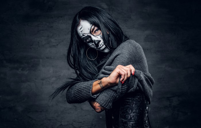 Woman with Day of the Dead makeup wearing a sweater