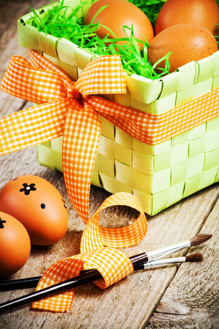 Easter eggs in a basket with paintbrushes