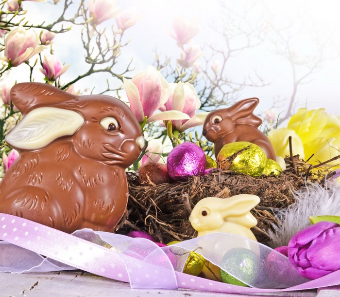 Easter Chocolate Bunnies and Eggs in a Nest with Flowers