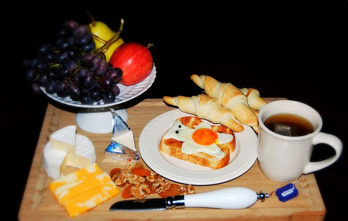 Breakfast with tea, croissants, and fruit