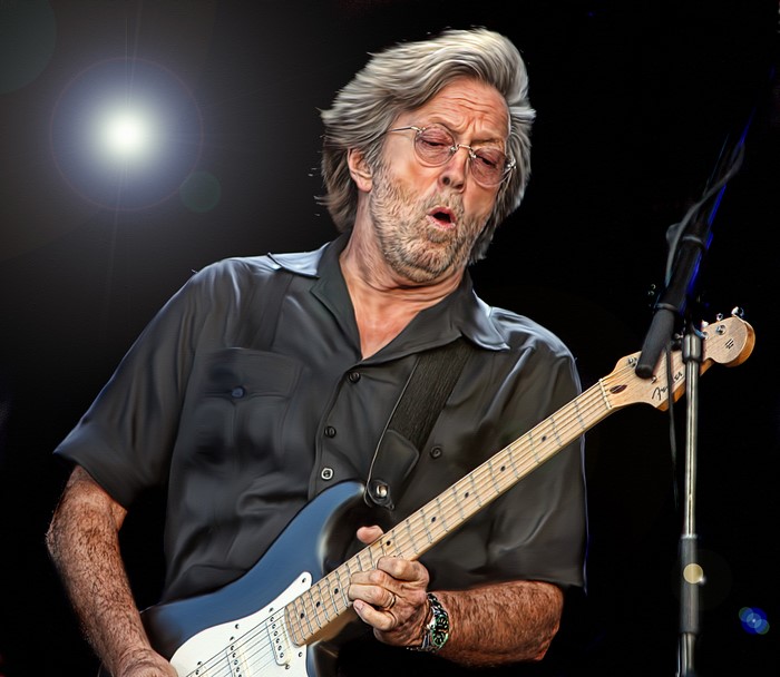 Eric Clapton playing guitar on stage