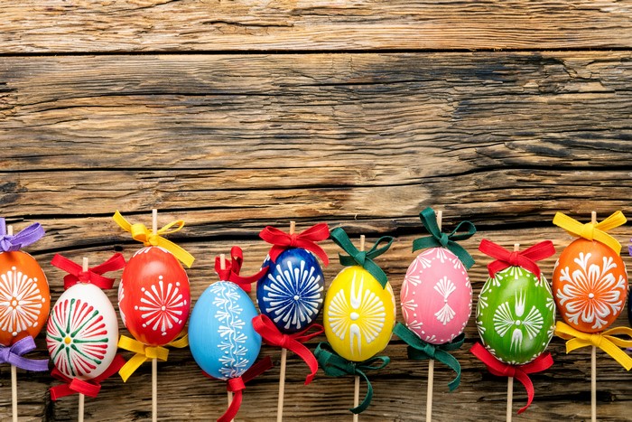 Easter Eggs with Bows on Wooden Background