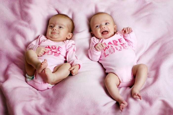 Two infants in pink onesies