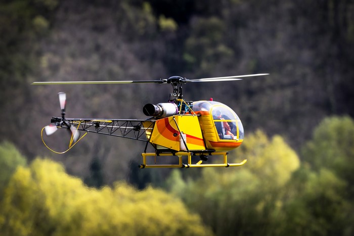 Yellow toy helicopter in flight