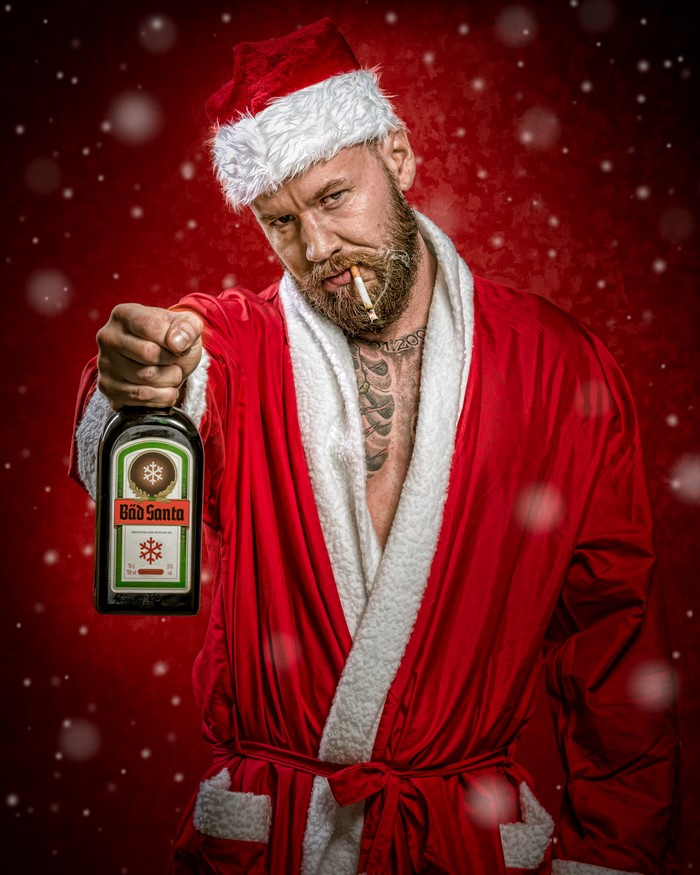 Man in Santa costume holding Jägermeister bottle