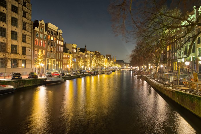 Amsterdam Canal at Night with Illuminated Houses