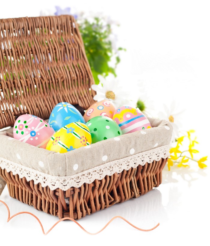 Easter eggs in a wicker basket with flowers