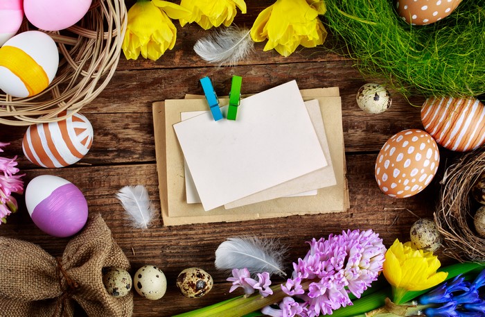 Easter eggs and flowers on wooden planks