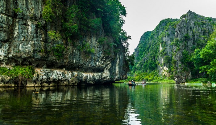 Boats on a river surrounded by karst mountains in Vietnam