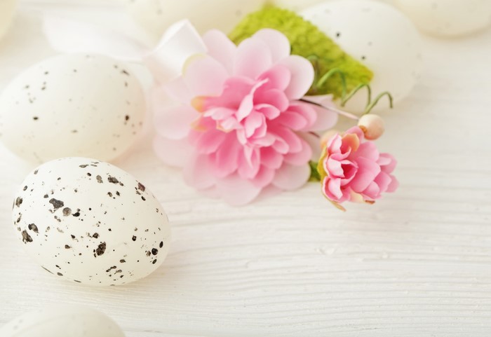 Easter eggs with pink flowers and ribbon