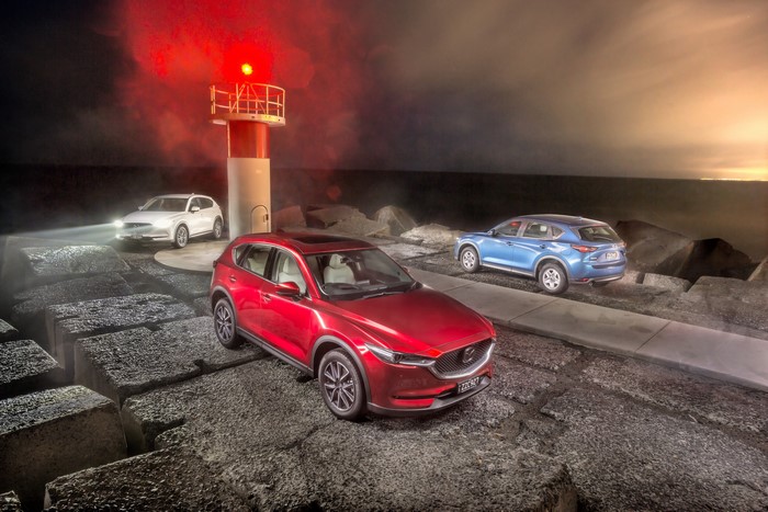 Three Mazda CX-5s at a Lighthouse