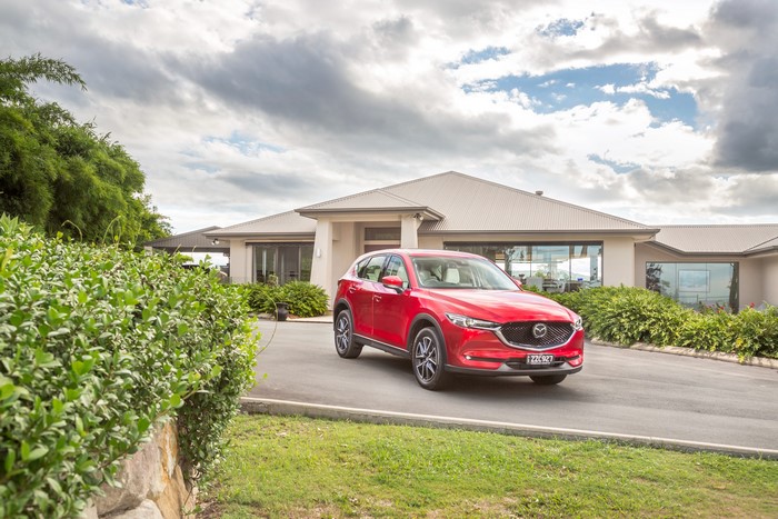 Red 2017 Mazda CX-5 Akera parked in front of a house
