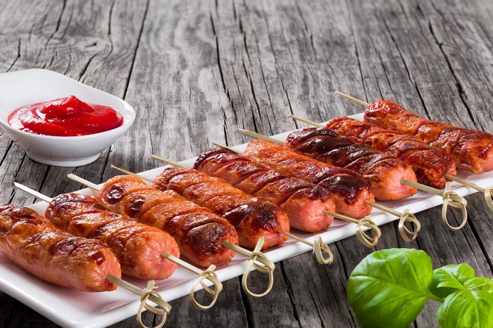 Sausages on skewers with ketchup