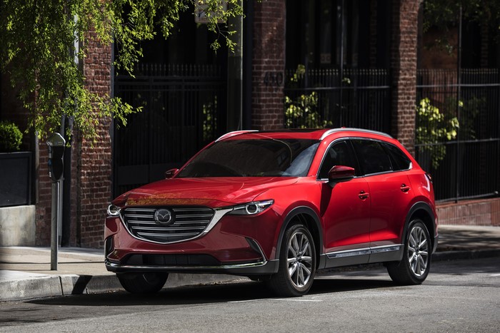 Red Mazda CX-9 parked on a city street