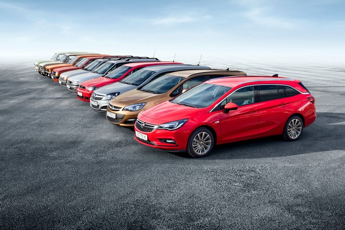 Many Opel cars lined up on asphalt