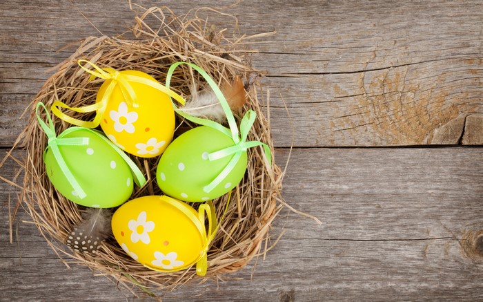 Easter eggs in a nest on wood planks