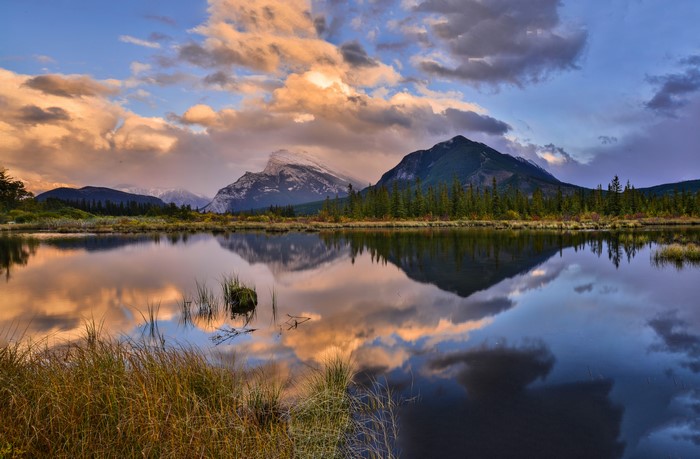 Mountains reflected in a lake at sunset in Banff National Park