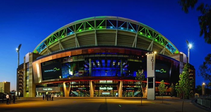 Adelaide Oval stadium at dusk with lights