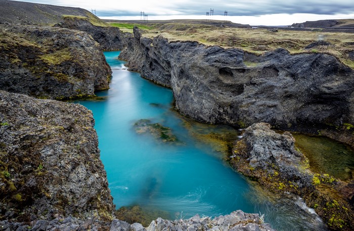 Turquoise river flowing through a rocky canyon in Iceland