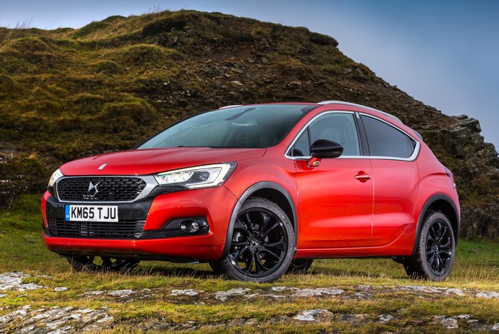 Red DS 4 Crossback parked on grassy terrain