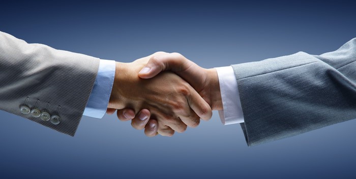 Business handshake between two men in suits