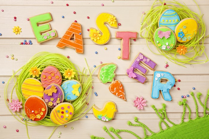 Easter cookies spelling out "EASTER" with decorated eggs in nests
