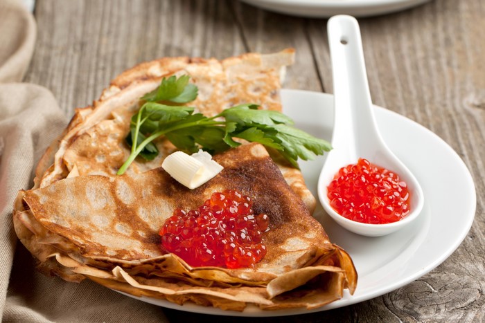 Pancakes with Caviar and Butter on a Plate