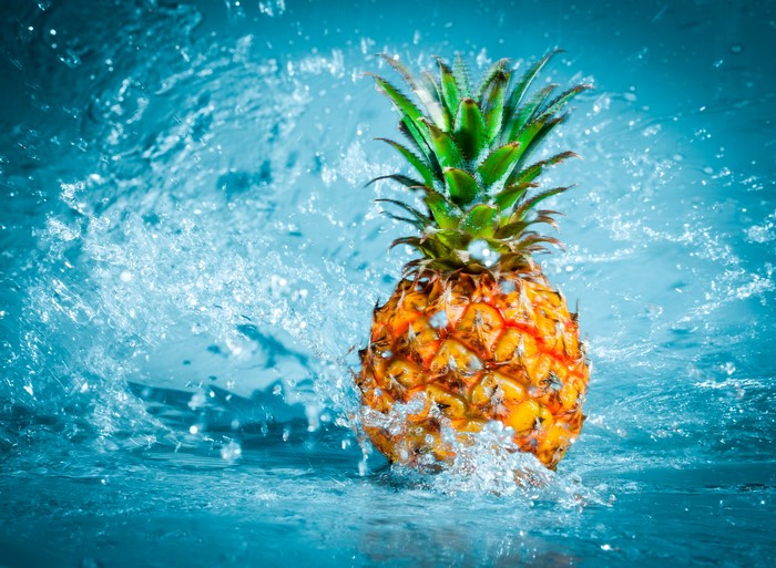 Pineapple splashing in water