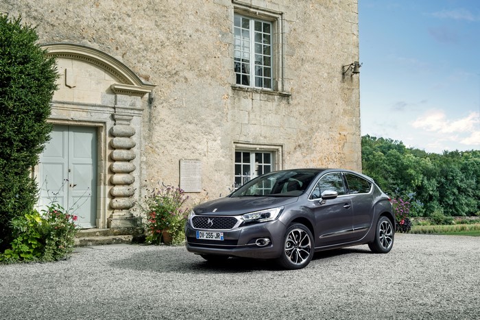 Grey DS 4 parked in front of a stone building