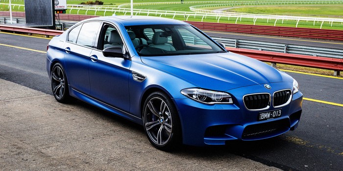 Blue BMW M5 F10 Sedan on a Racetrack
