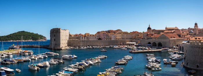 Dubrovnik harbor with boats and old city walls
