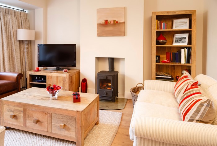 Living room with sofa, table, and fireplace