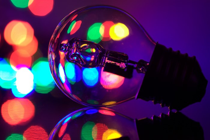 Closeup of a light bulb with colorful bokeh lights