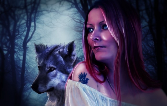 Woman with wolf in a dark forest