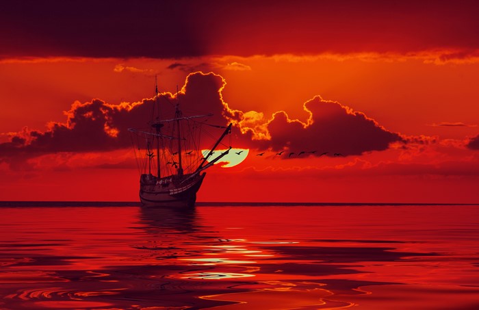 Ship sailing on the sea during sunset