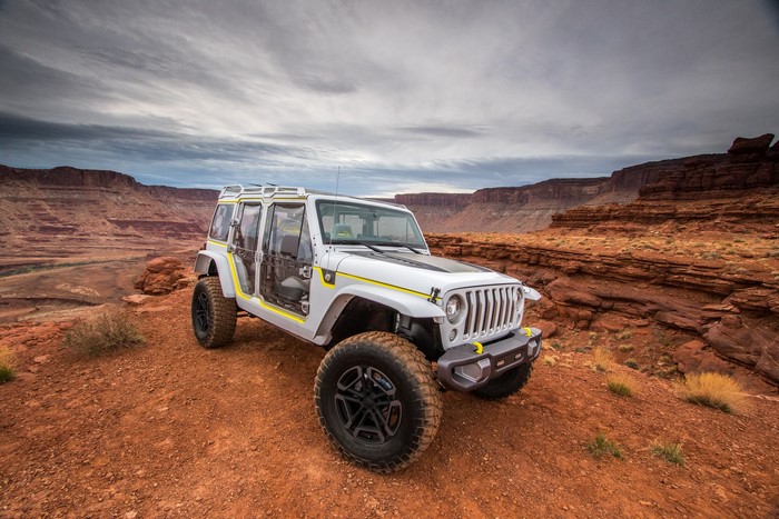 White Jeep Wrangler 4xe concept off-roading in desert canyon