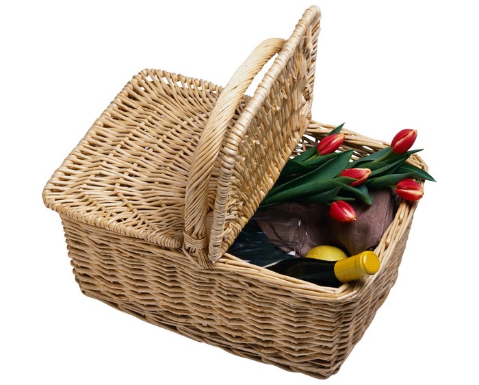 Wicker picnic basket with tulips, wine, and lemon