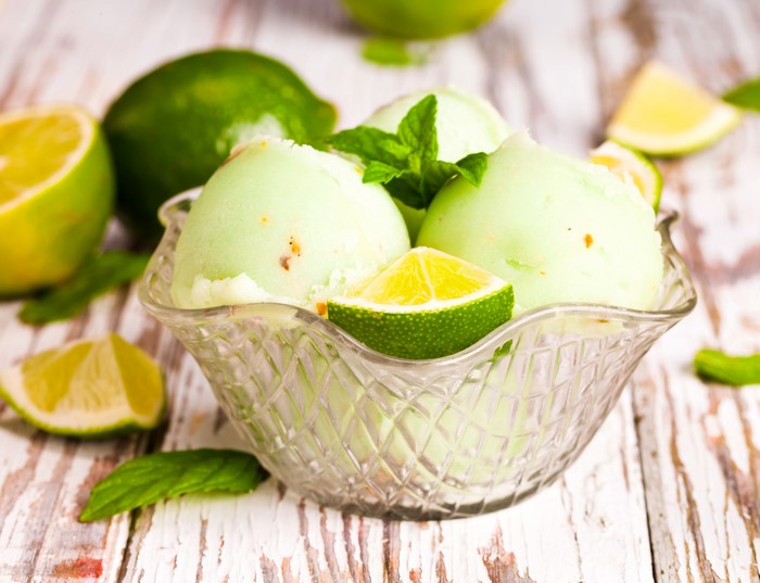Lime ice cream in a bowl with mint and lime slices