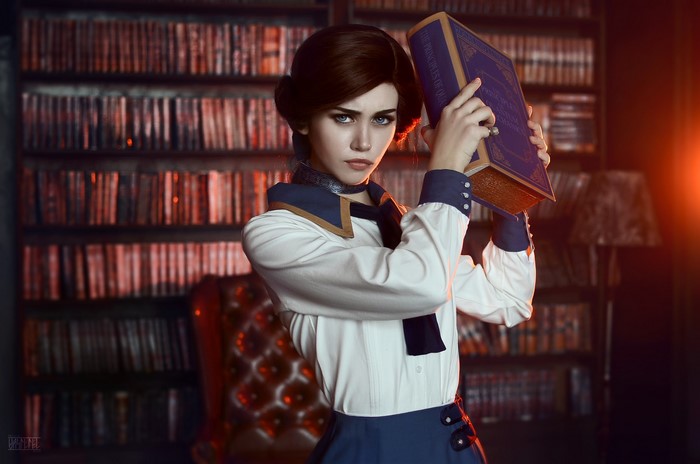 Elizabeth from BioShock Infinite holding a book in a library